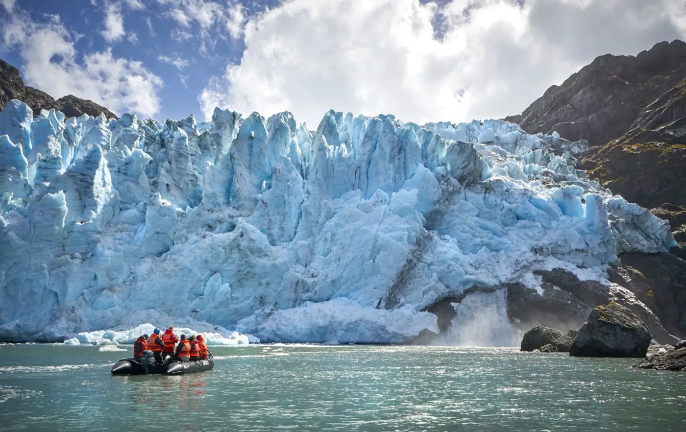 Zodiac excursion in front of a glacier wall in the Darwin mountain range