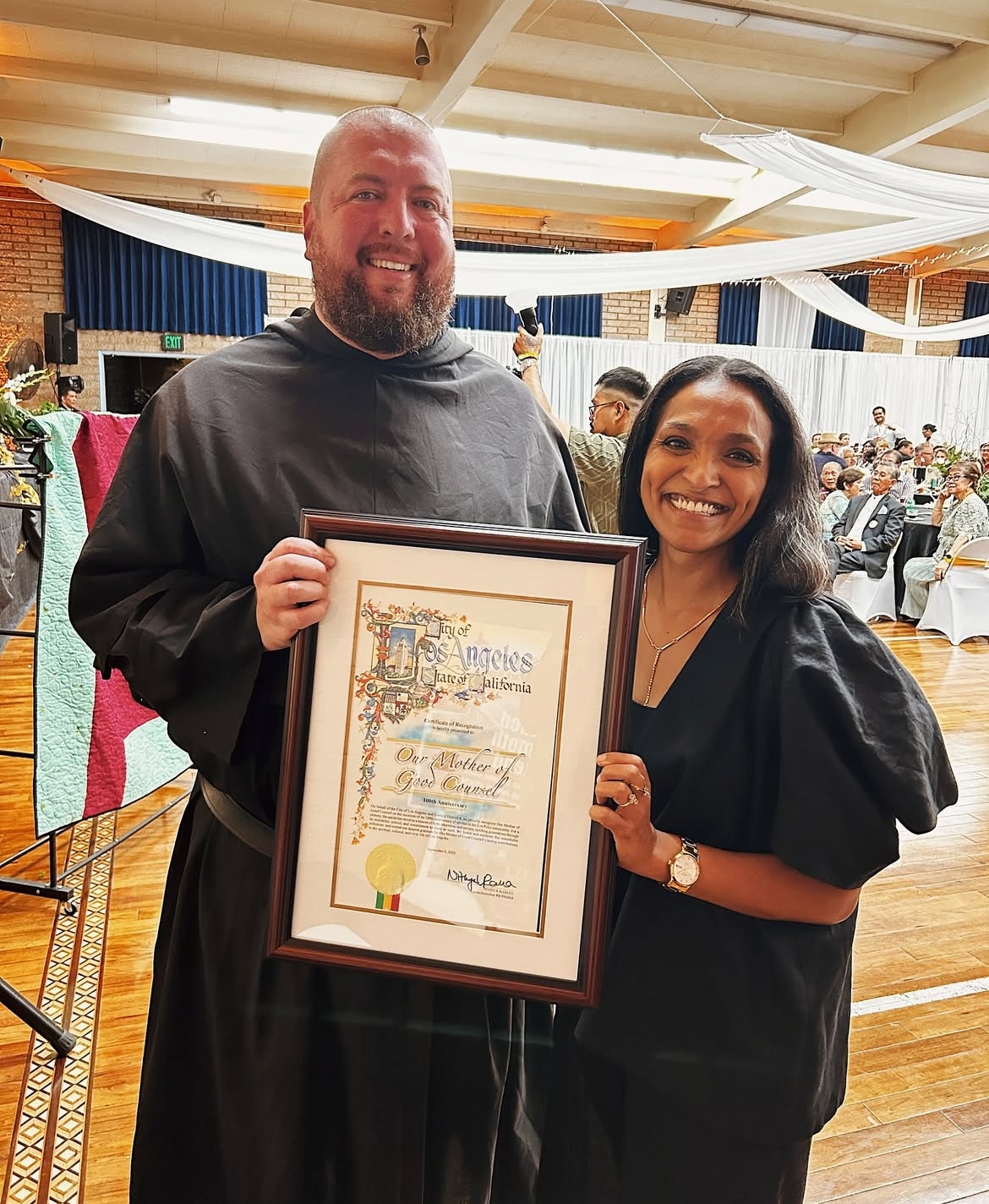 Councilmember Raman presents certificate to Parish leader at Our Mother of Good Counsel
