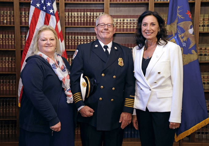 Michigan state Representative Angela Witwer and Olivet Firefighter's Chief John Collins and his wife. Michigan state Representative Angela Witwer and Olivet Firefighter's Chief John Collins and his wife.