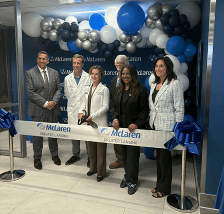 Michigan state Representative Angela Witwer standing with staff from the new McLaren Delta Township Grand Ledge Emergency Department and Ambulatory Care Center behind a celebratory McLaren ribbon. Above them is a blue and white balloon display. Michigan state Representative Angela Witwer standing with staff from the new McLaren Delta Township Grand Ledge Emergency Department and Ambulatory Care Center behind a celebratory McLaren ribbon. Above them is a blue and white balloon display.