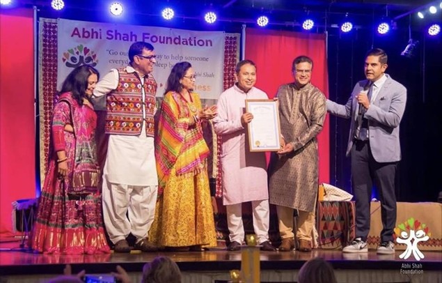 Democratic Leader Ranjeev Puri presenting a tribute on stage to members of the Abhi Shah Foundation. Democratic Leader Ranjeev Puri presenting a tribute on stage to members of the Abhi Shah Foundation.