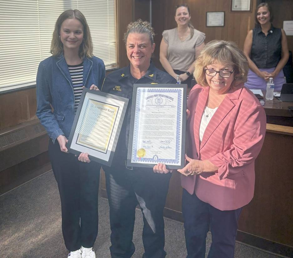 Michigan state Representative Reggie Miller and Belleville Police Chief Kristin Faull posing for a photo with her certificate marking her 25th year of service with the Belleville Police Department. Michigan state Representative Reggie Miller and Belleville Police Chief Kristin Faull posing for a photo with her certificate marking her 25th year of service with the Belleville Police Department.
