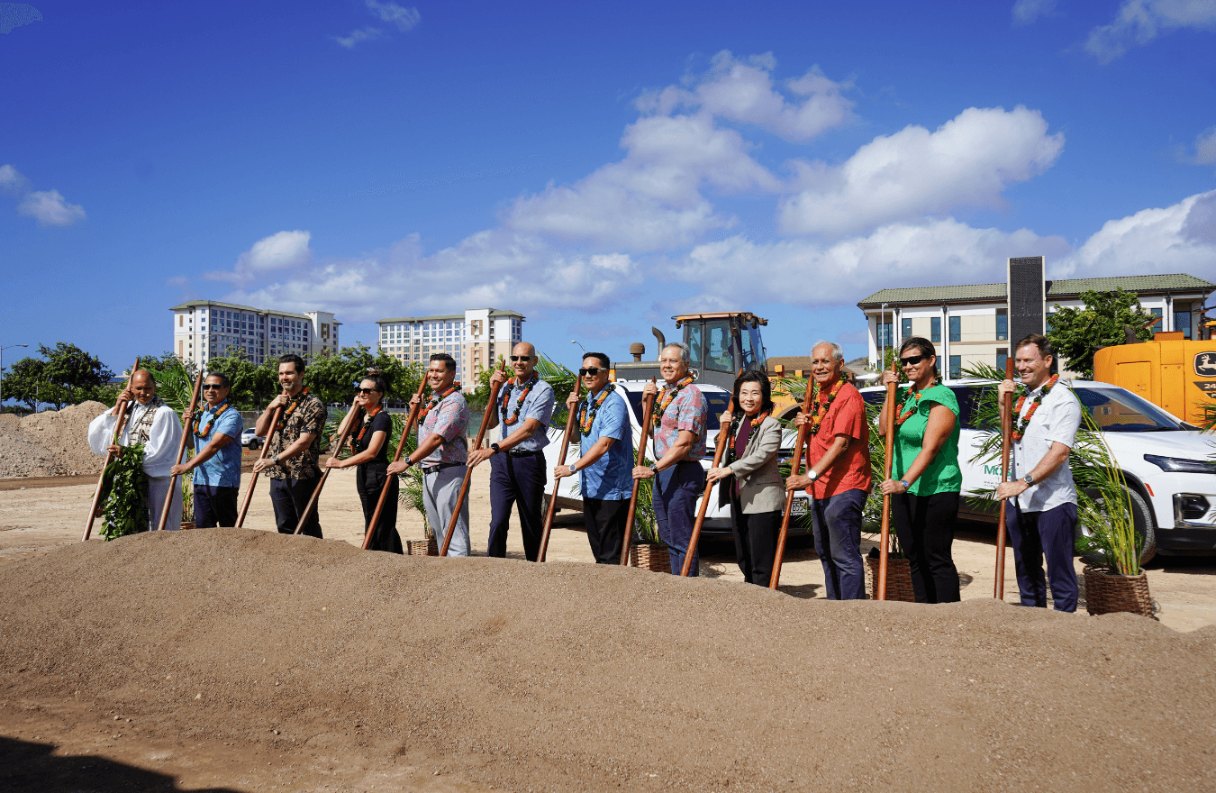 Lt. Gov. Sylvia Luke, legislators, and community leaders holding oʻo sticks next to a pile of dirt. 