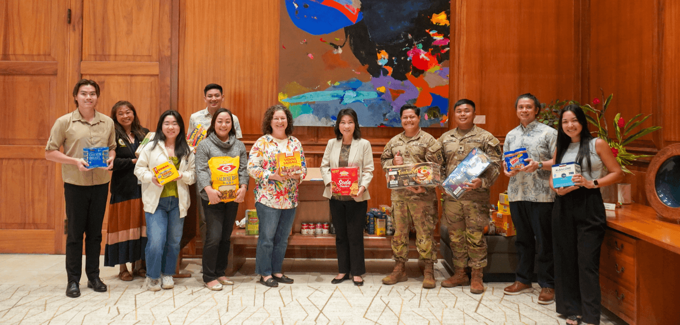 Lt. Gov. Sylvia Luke, National Guard members, and staff holding food donations. 