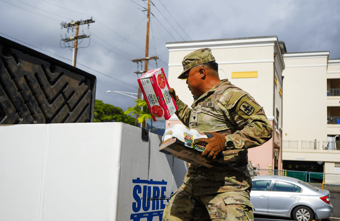 National Guard member handling food donations. 