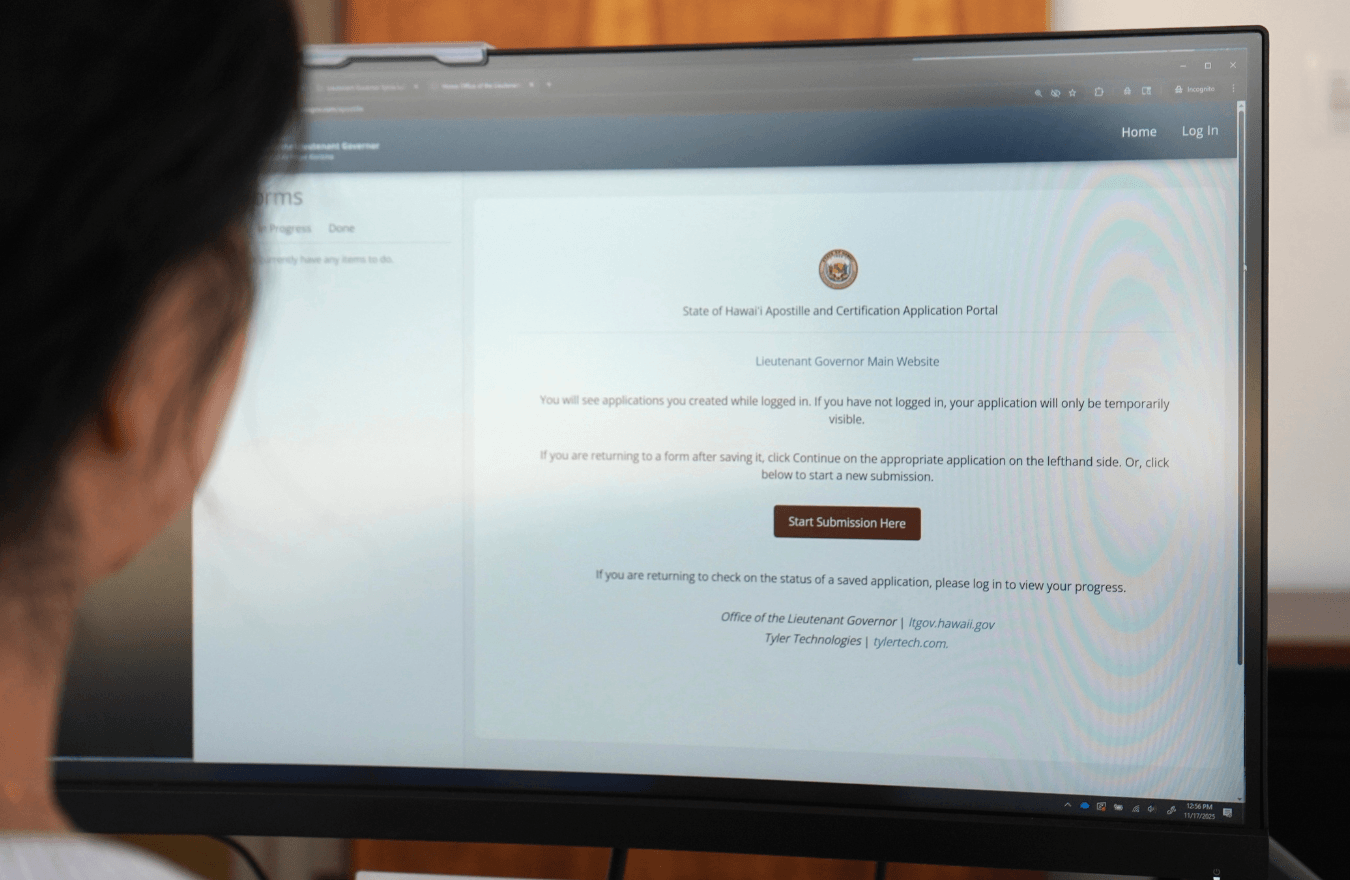 Computer screen with homepage of apostille online application. 