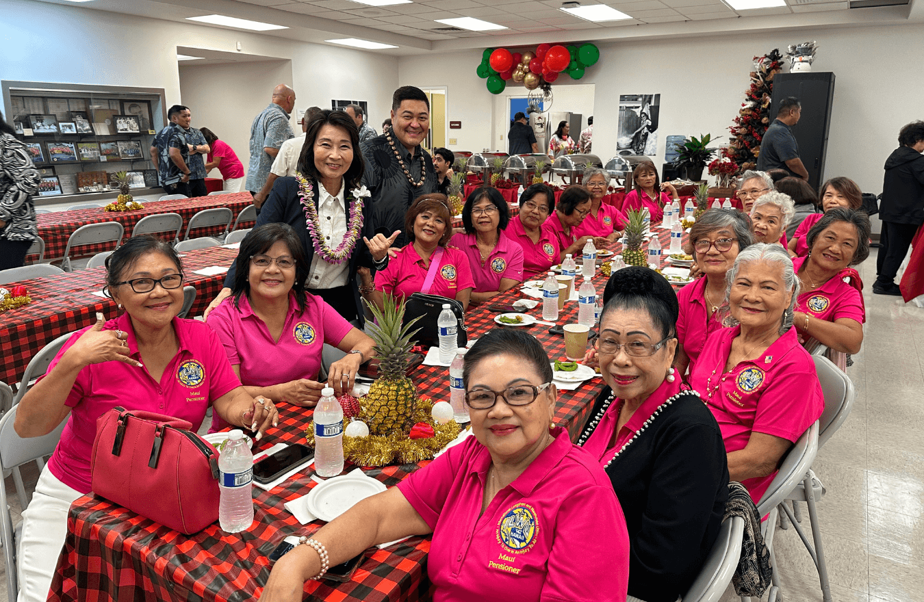 Lt. Gov. Sylvia Luke, a legislator, and group smiling for a group picture. 