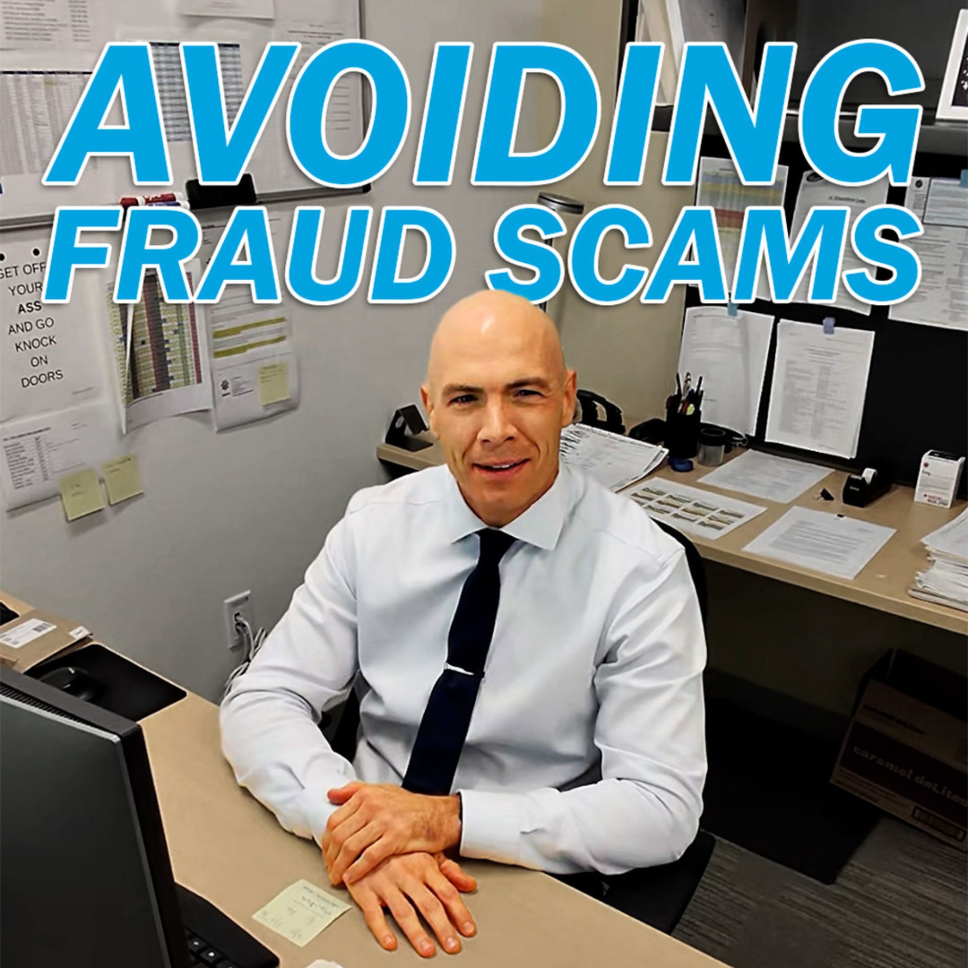 Avoiding Fraud Scams man working on his desk with a black tie and alot of paper around him.