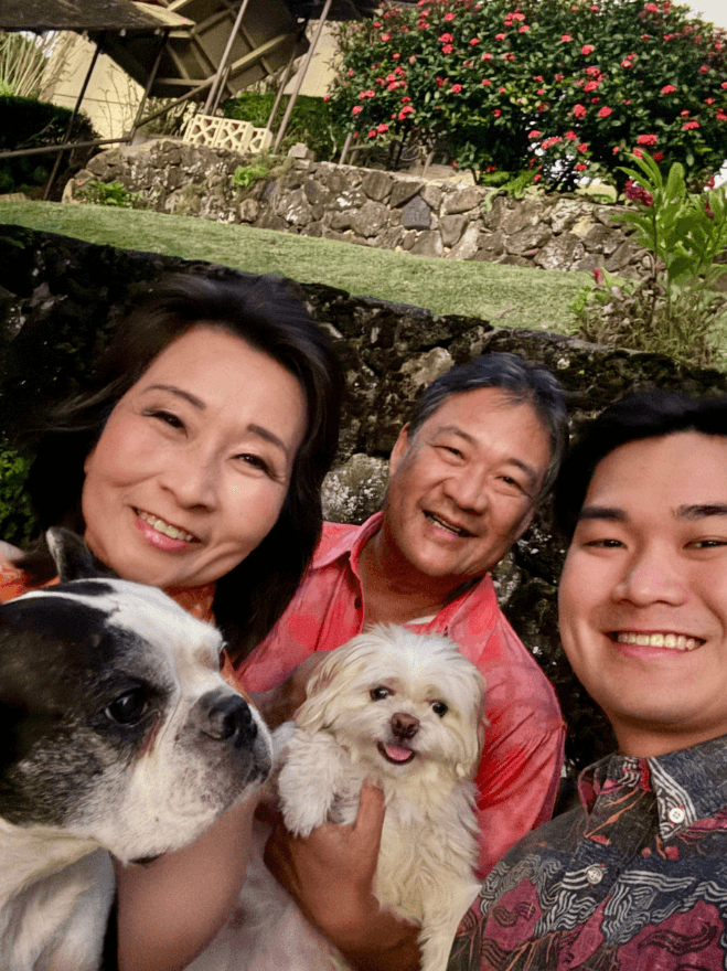Lt. Gov. Sylvia Luke and group smiling outdoors while holding two dogs. 