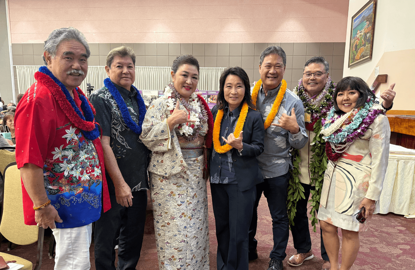Lt. Gov. Sylvia Luke and group smiling for a group photo while holding up shakas. 