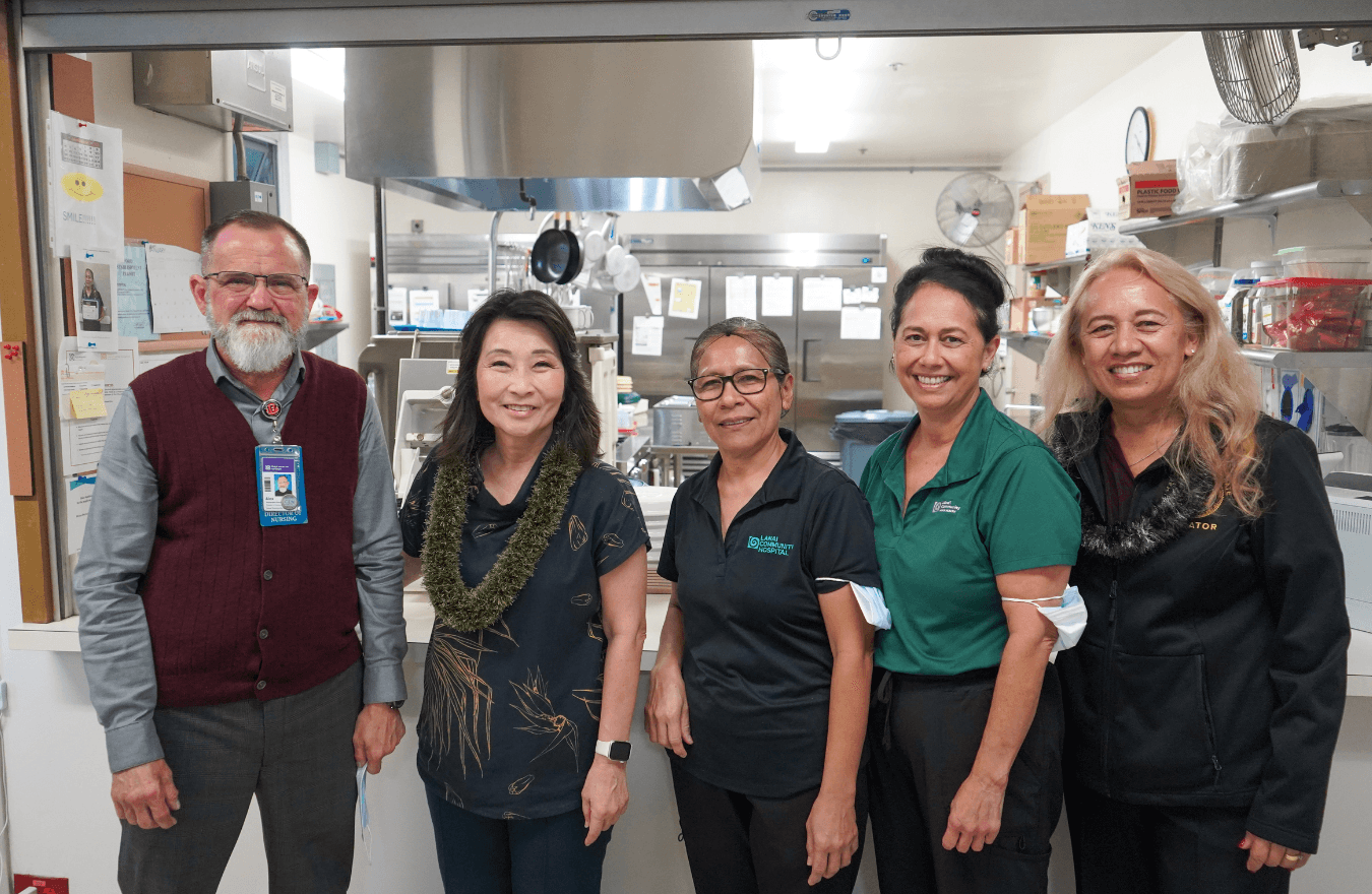 Lt. Gov. Sylvia Luke, a legislator, and group smiling for a group photo. 