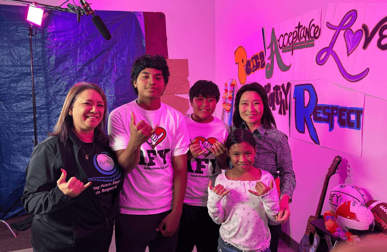 Lt. Gov. Sylvia Luke and group smiling for a group photo while holding up shakas. 
