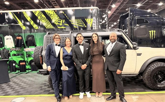 Democratic Leader Ranjeev Puri with staff in front of a car at the Detroit Auto Show Charity Preview event. Democratic Leader Ranjeev Puri with staff in front of a car at the Detroit Auto Show Charity Preview event.