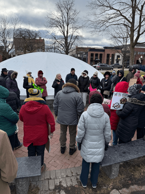 Democratic Leader Ranjeev Puri with community members outside holding protest signs. Democratic Leader Ranjeev Puri with community members outside holding protest signs.