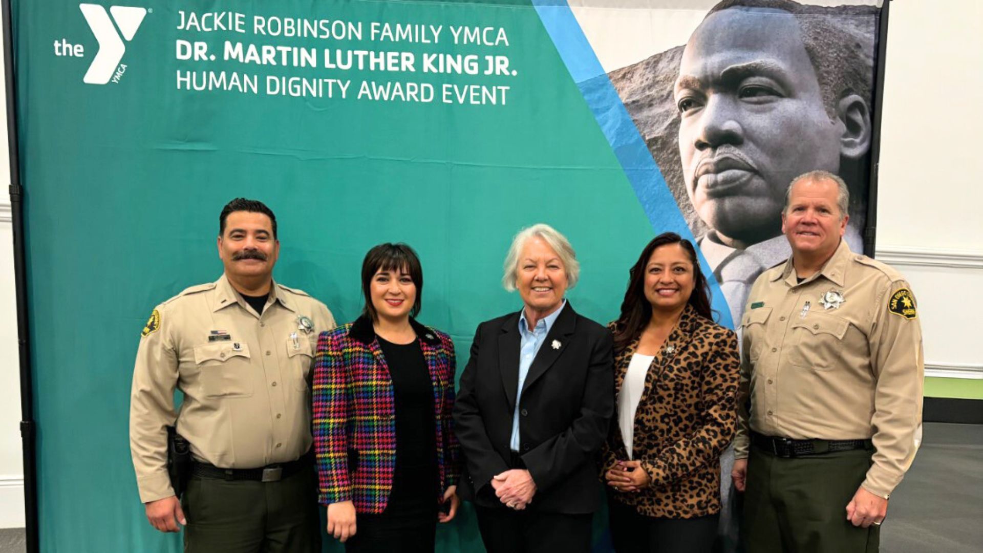 Avoiding Fraud Scams man working on his desk with a black tie and alot of paper around him.