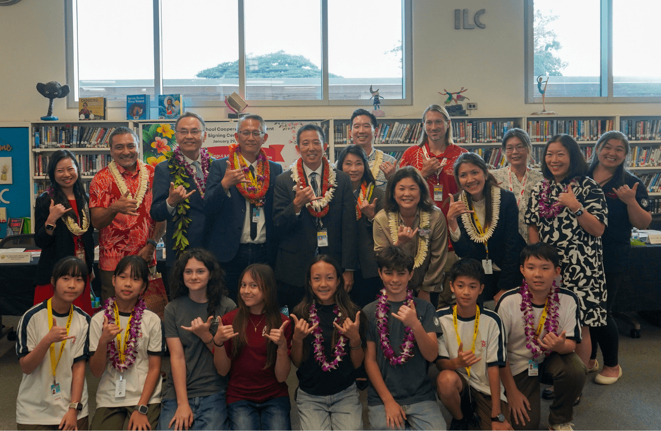 Lt. Gov. Sylvia Luke, legislators, school administration, teachers, and middle school students smiling and holding up shakas for a group photo. 