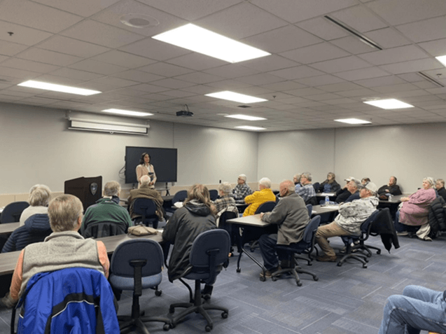 Michigan State Representative Angela Witwer speaking to a crowd of community members. Michigan State Representative Angela Witwer speaking to a crowd of community members.
