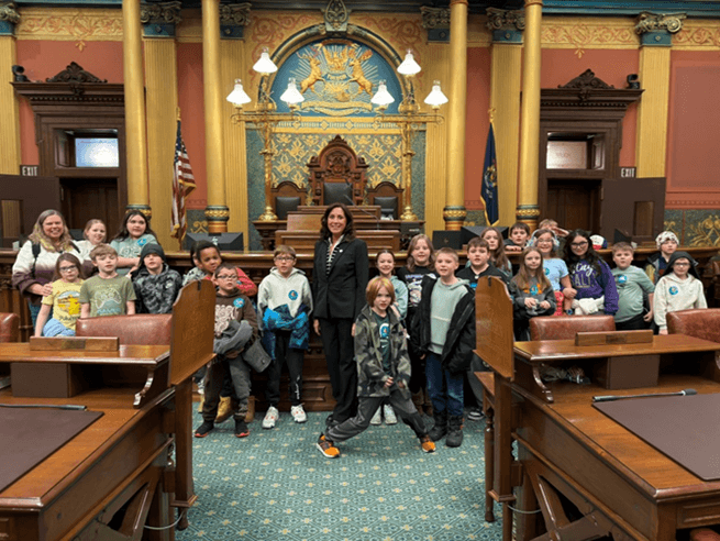 Michigan State Representative Angela Witwer with a class of elementary schoolers from Charlotte Public Schools on the House floor. Michigan State Representative Angela Witwer with a class of elementary schoolers from Charlotte Public Schools on the House floor.