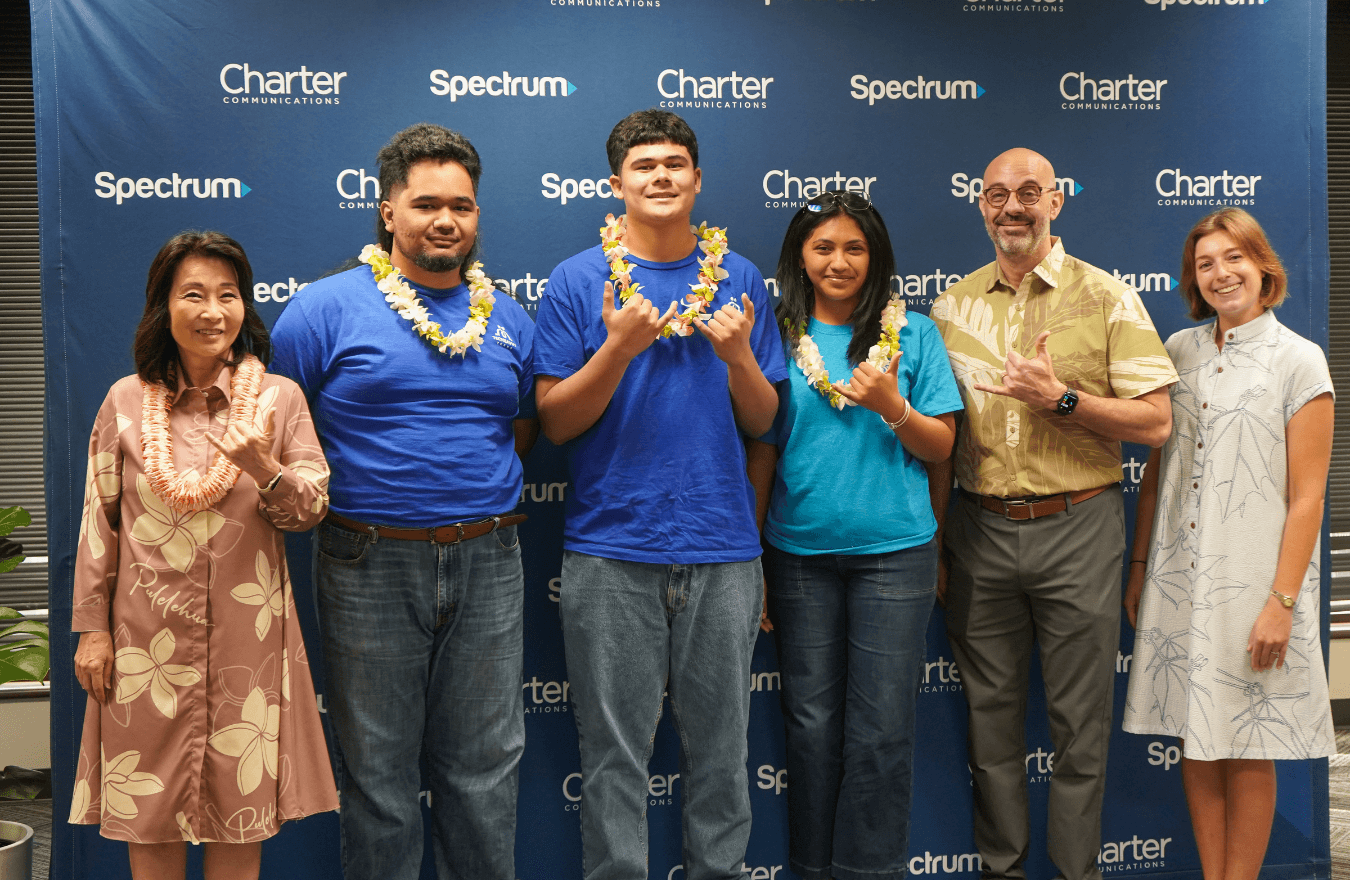 Lt. Gov. Sylvia Luke and group smiling and holding up shakas for a group photo. 