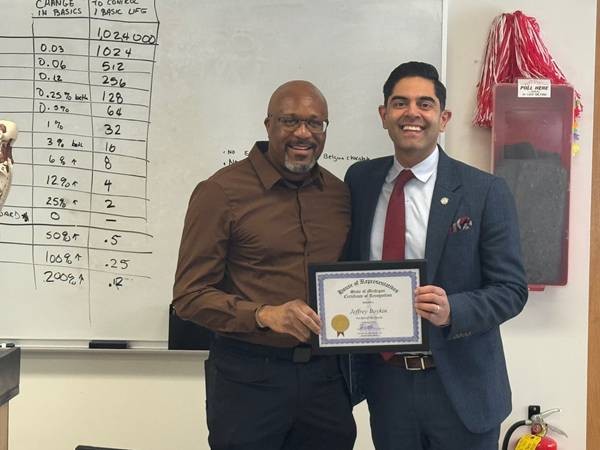 Democratic Leader Ranjeev Puri with Mr. Boykin holding his February Teacher of the Month framed certificate in a classroom. Democratic Leader Ranjeev Puri with Mr. Boykin holding his February Teacher of the Month framed certificate in a classroom.
