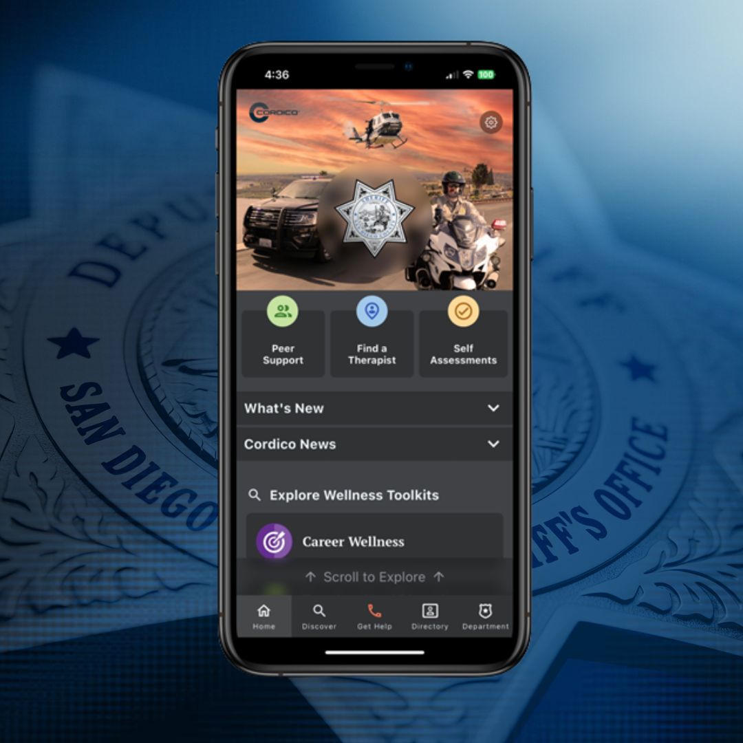 Avoiding Fraud Scams man working on his desk with a black tie and alot of paper around him.