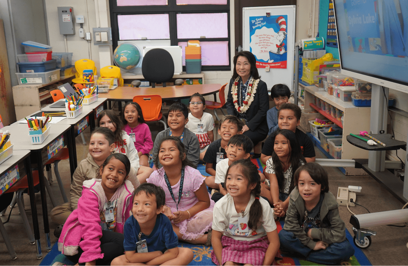 Lt. Gov. Sylvia Luke and group of students smiling for a group picture in a classroom. 