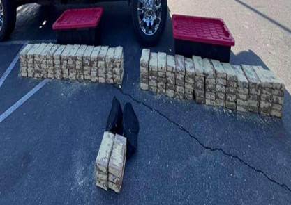 Senior Volunteer patrol giving a pie to an elderly women wearing a white shirt with a black and yellow patch.