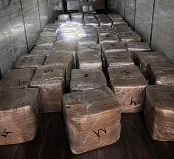 Senior Volunteer patrol giving a pie to an elderly women wearing a white shirt with a black and yellow patch.