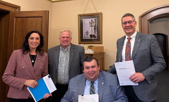 Michigan state Representatives Witwer, Kunse, Meerman and Snyder holding their bills up for a photo. Michigan state Representatives Witwer, Kunse, Meerman and Snyder holding their bills up for a photo.