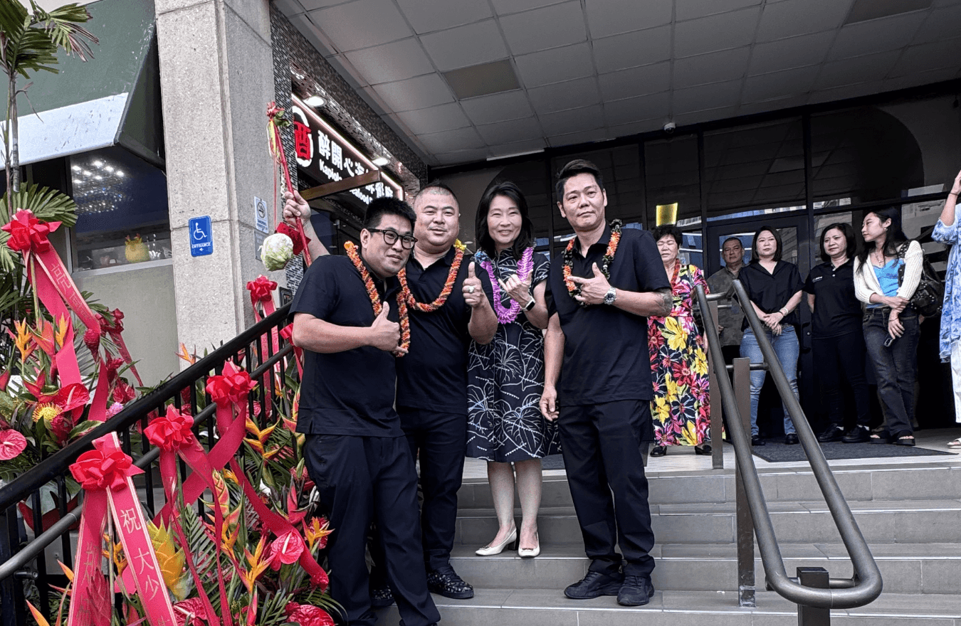 Lt. Gov. Sylvia Luke and group smiling and holding up shakas for a photo while standing on a short set of stairs. 