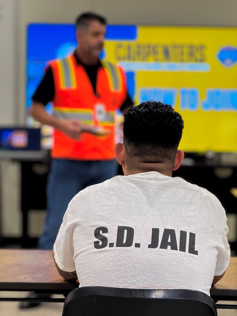 Construction worker teaching an ip about the job.