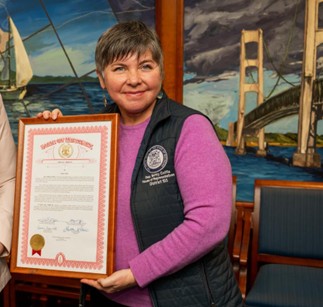 State Representative Betsy Coffia presenting a framed tribute certificate for Ashley Ochoa. State Representative Betsy Coffia presenting a framed tribute certificate for Ashley Ochoa.