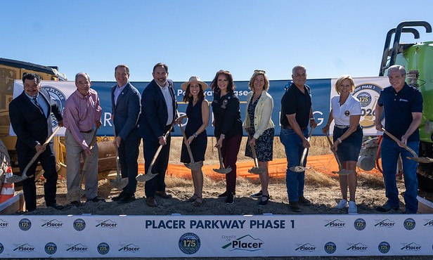 Placer County supervisors and dignitaries holding shovels of dirt, and an aerial rendering of the future Placer Parkway project.