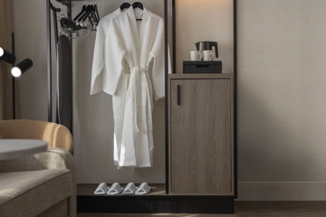 Wardrobe with bathrobe, slippers, coffee& tea amenities and ironing board
