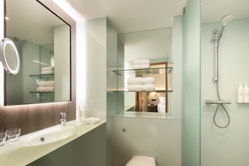 Bright bathroom with make up mirror, shower and toilet