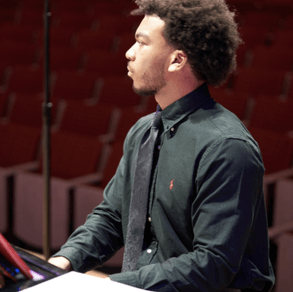 Isaiah Dobbins plays the piano.