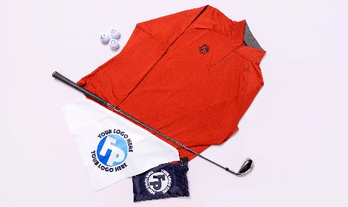 An array of golf products including a branded Fully Promoted red jacket, branded Fully Promoted golf balls, and Screen Printed Fully Promoted golf flags.