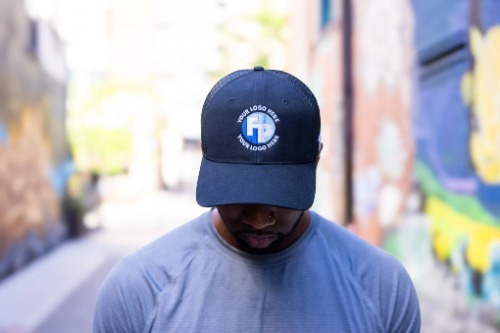 A man wearing a blue fully promoted branded hat.