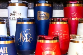 An assortment of branded drinkware including mugs and cups.