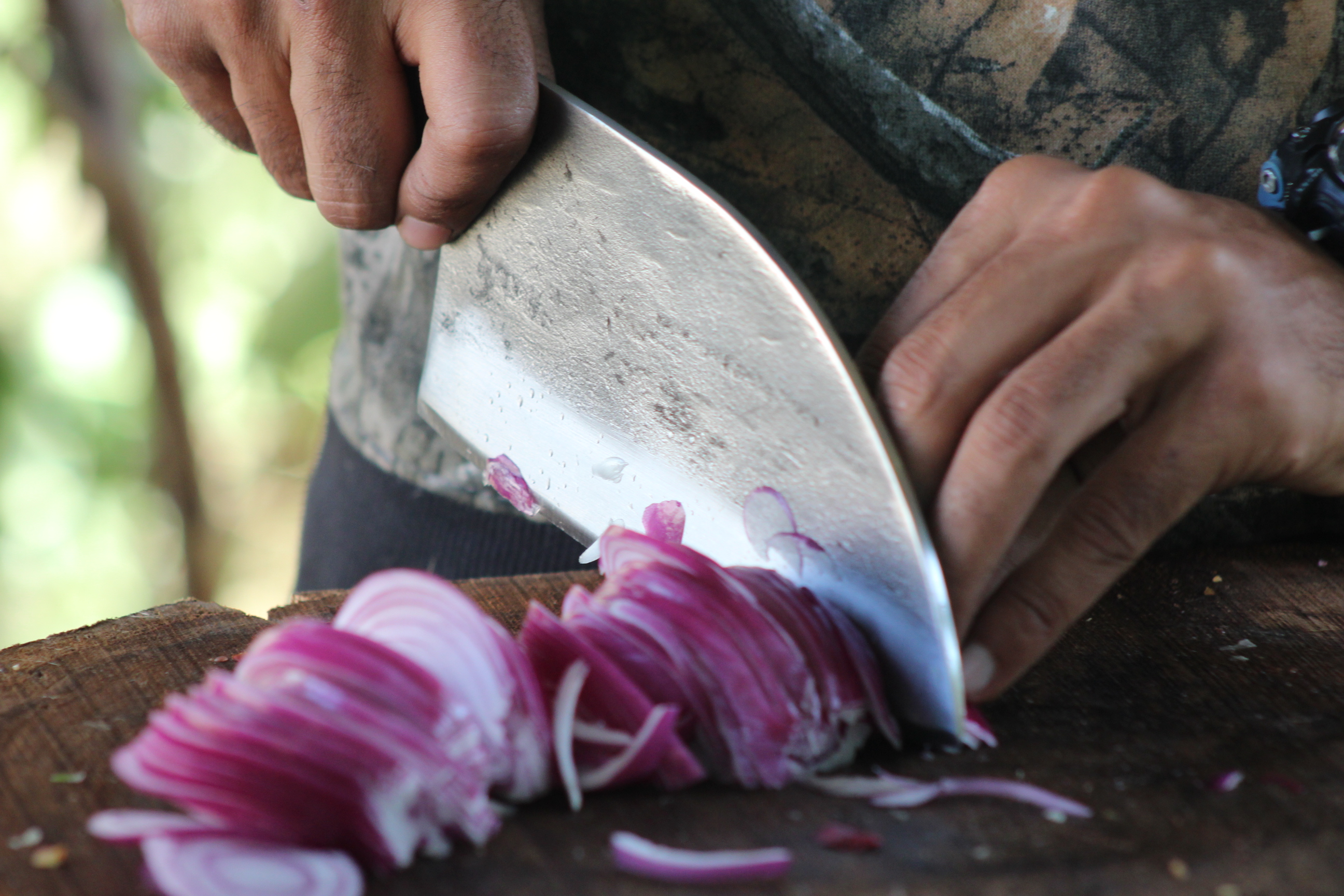 Close-up of a knife cutting food precisely