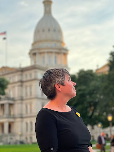 Michigan State Representative Betsy Coffia at the Michigan State Capitol, wearing a sunshine BRITE Act pin. Michigan State Representative Betsy Coffia at the Michigan State Capitol, wearing a sunshine BRITE Act pin.