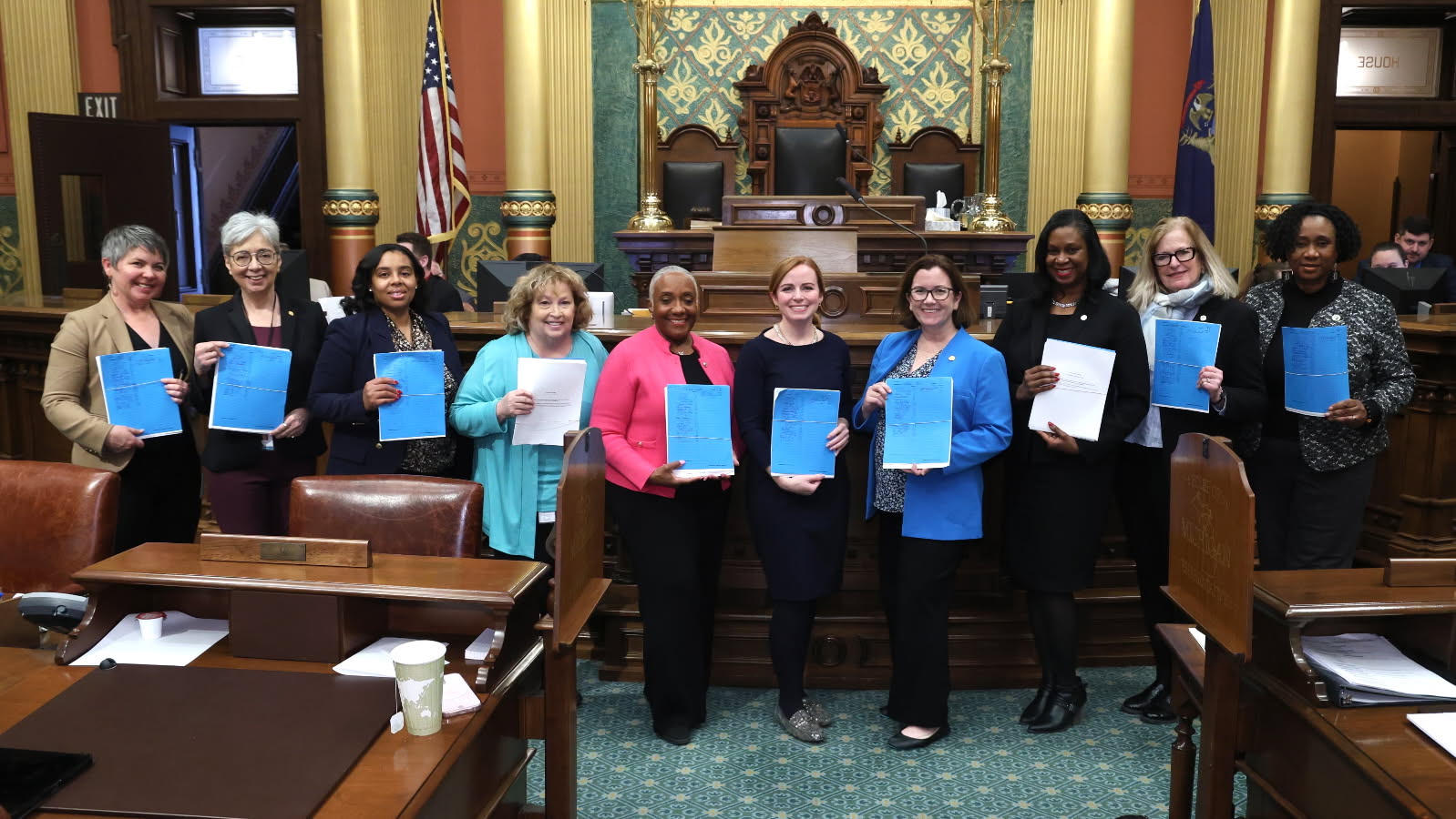 Michigan State Representative Reggie Miller stands with fellow Democratic representatives in holding up their pay equity legislation. Michigan State Representative Reggie Miller stands with fellow Democratic representatives in holding up their pay equity legislation.