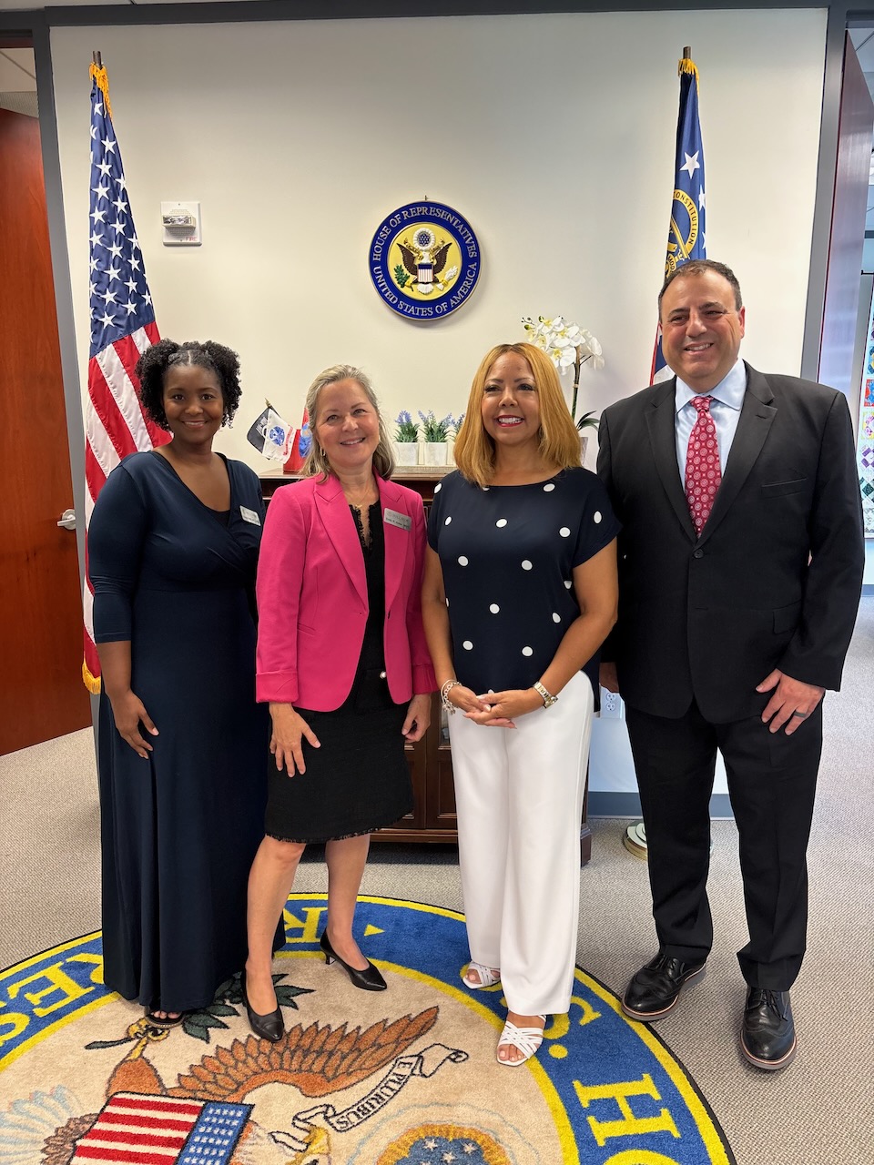 Rep. McBath with leadership from Hillside in front of an American flag and the Georgia state flag.