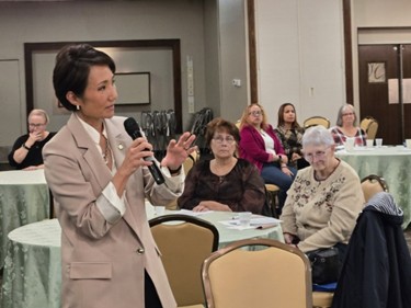 Senator Patty Kim speaking with a microphone at the GRG Conference.