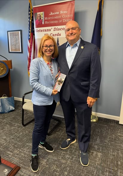 a photo of Montgomery COunty Recorder of Deeds Jean Sorg and Representative Ben Sanchez infront of the Veteran's Discount ID sign 