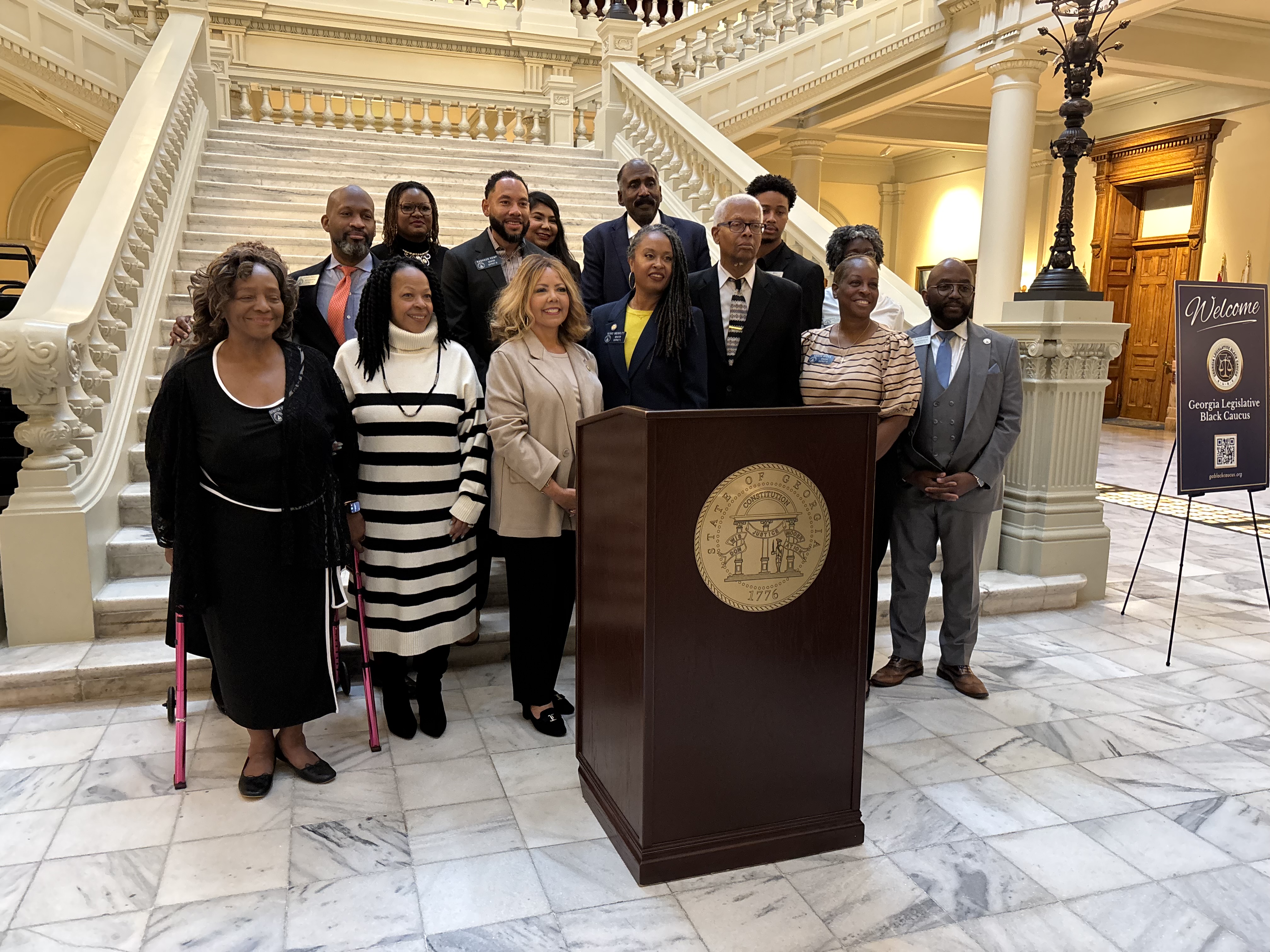 Congresswoman Lucy McBath stands with state Senator Nikki Merritt, Congressman Hank Johnson, and members of the Georgia Legislative Black Caucus.