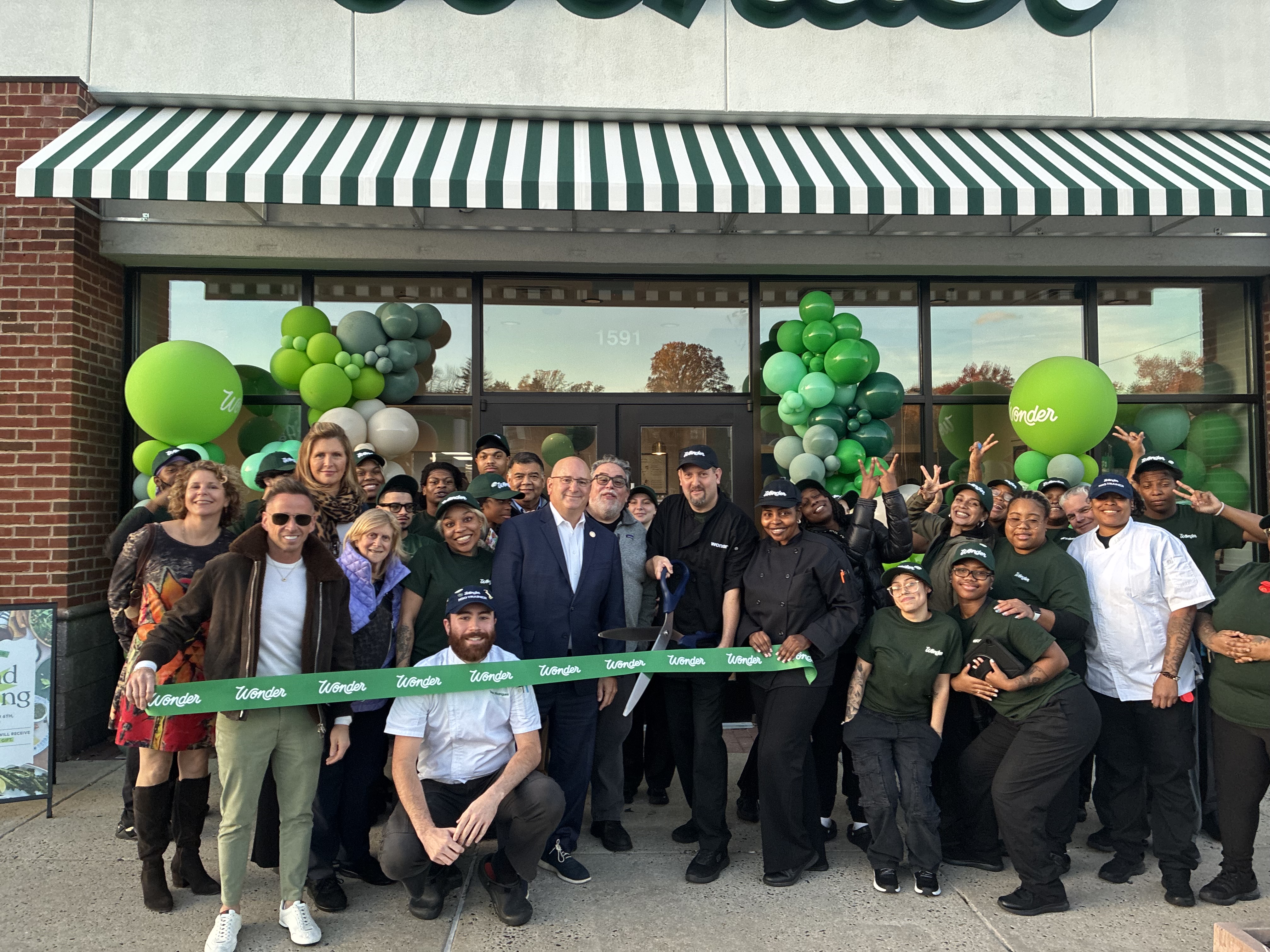 Wonder Foods Ribbon cutting image with Rep Sanchez, community members and Wonder staff.