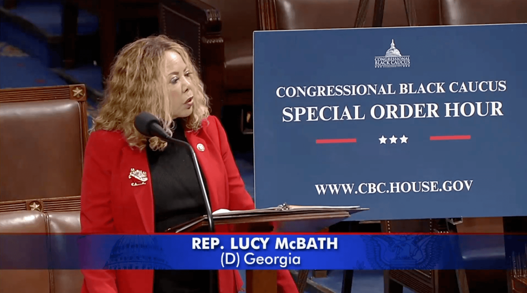 Screenshot of Rep. McBath speaking on the floor of the U.S. House of Representatives. A poster stands next to her reading "Congressional Black Caucus Special Order Hour."