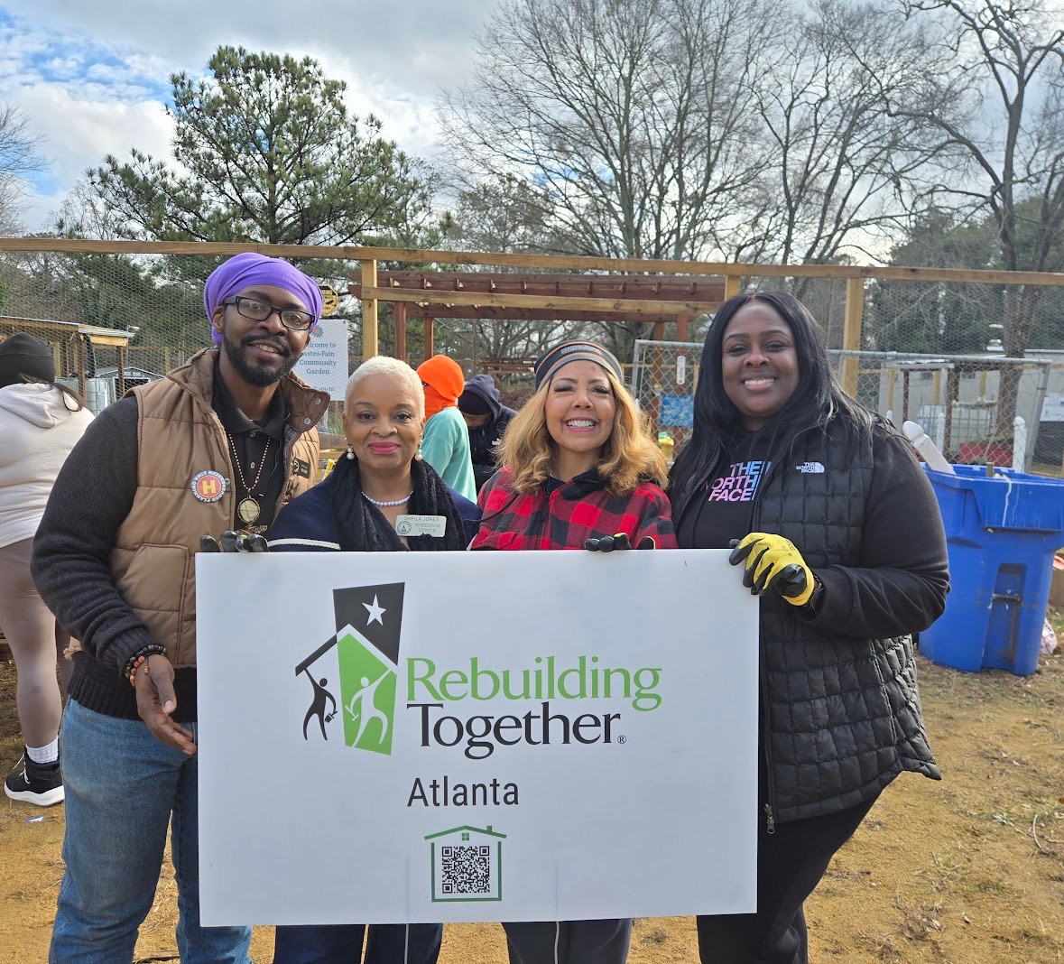 Photo of Rep. McBath with residents and elected leaders in west Atlanta in front of a sign that reads "Rebuilding Together Atlanta."