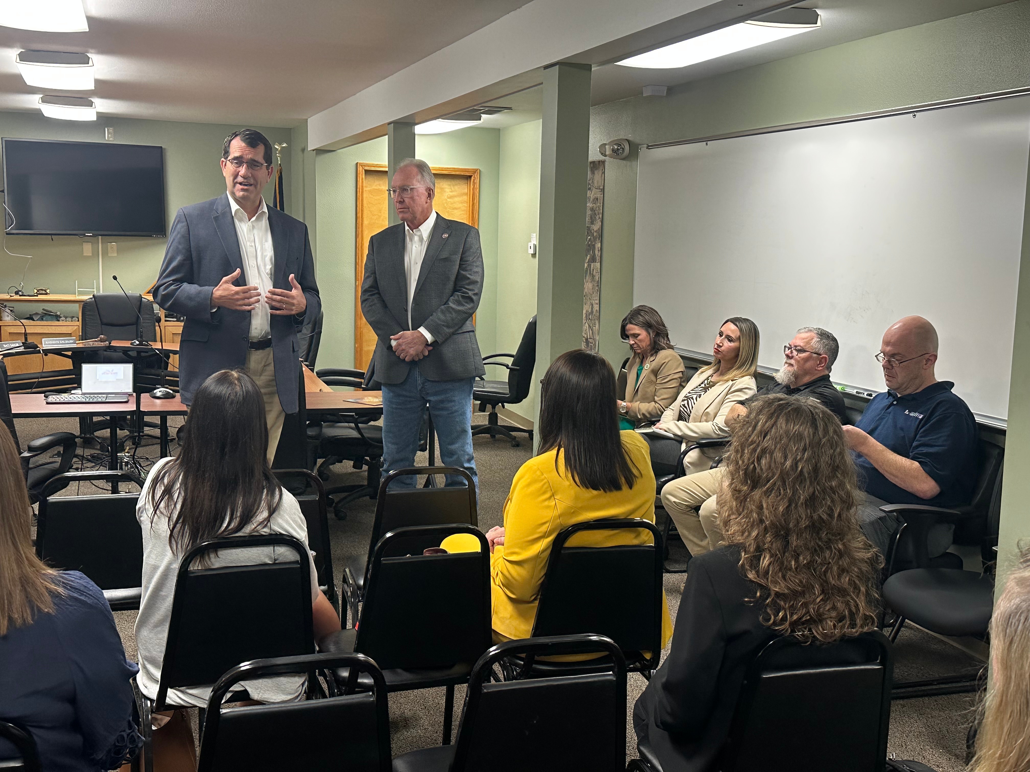 Rep. Derek Schmidt and USDA Undersecretary Glen Smith speak with attendees at the rural housing roundtable in Fort Scott
